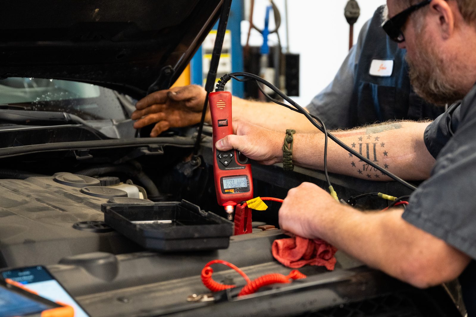 Technician testing an electrical system with a multimeter