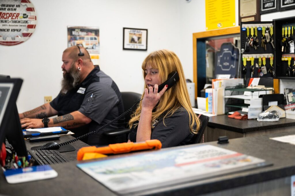 Katie and Kyle, service advisors, at the front desk of Kalispell Alignment and Auto Repair