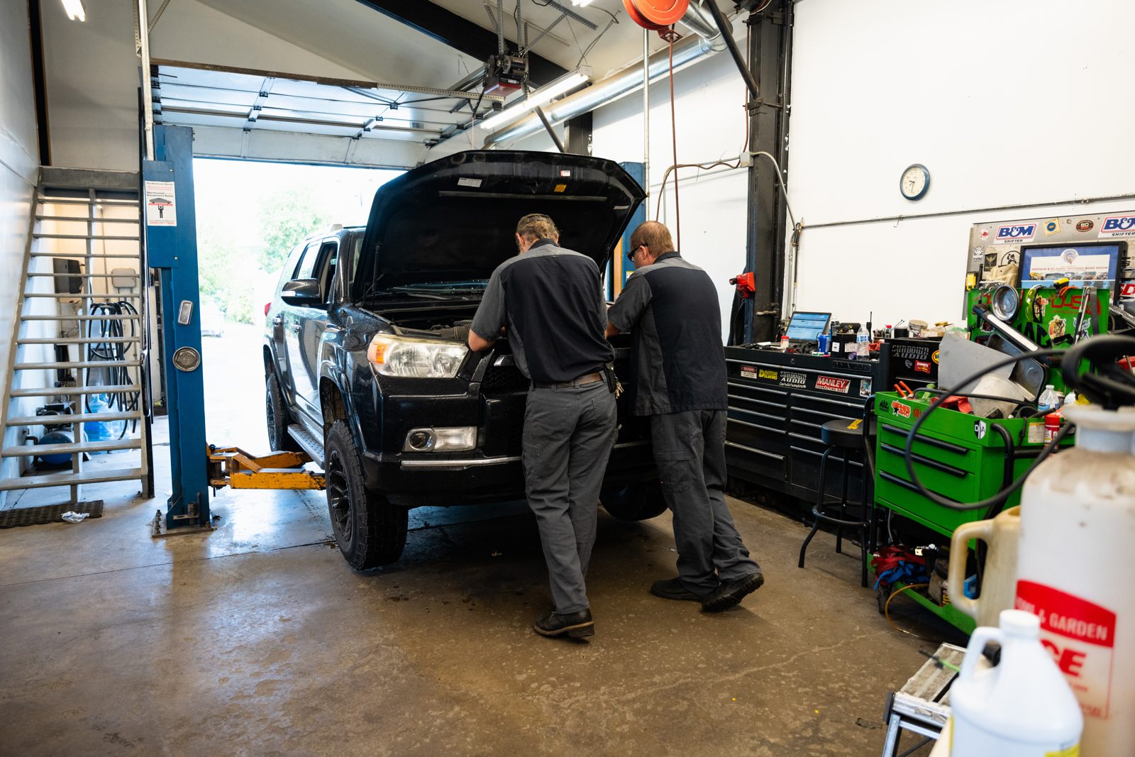 Two technicians working on a truck engine